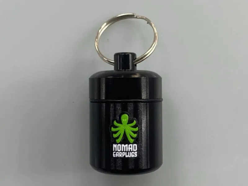 Nomad Earplugs black keychain carry case with green octopus logo